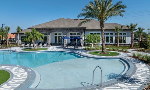 pool area showing reclining seating, wooden coverings and ample space