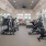 One-Bedroom Luxury Apartments in Winter Haven, FL - Prose Cypress Pointe - Fitness Center with Precor Equipment, Cardio Machines, Large Mirror on Wall, Oversized Windows, and A Tall Ceiling with a Fan
