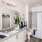 Two-Bedroom Luxury Apartments in Winter Haven, FL - Prose Cypress Pointe - Bathroom with Custom Cabinetry and Granite Countertops, Premium Plank Flooring, Shower and Tub Combo with a Curtain and a Vanity with a Large Mirror